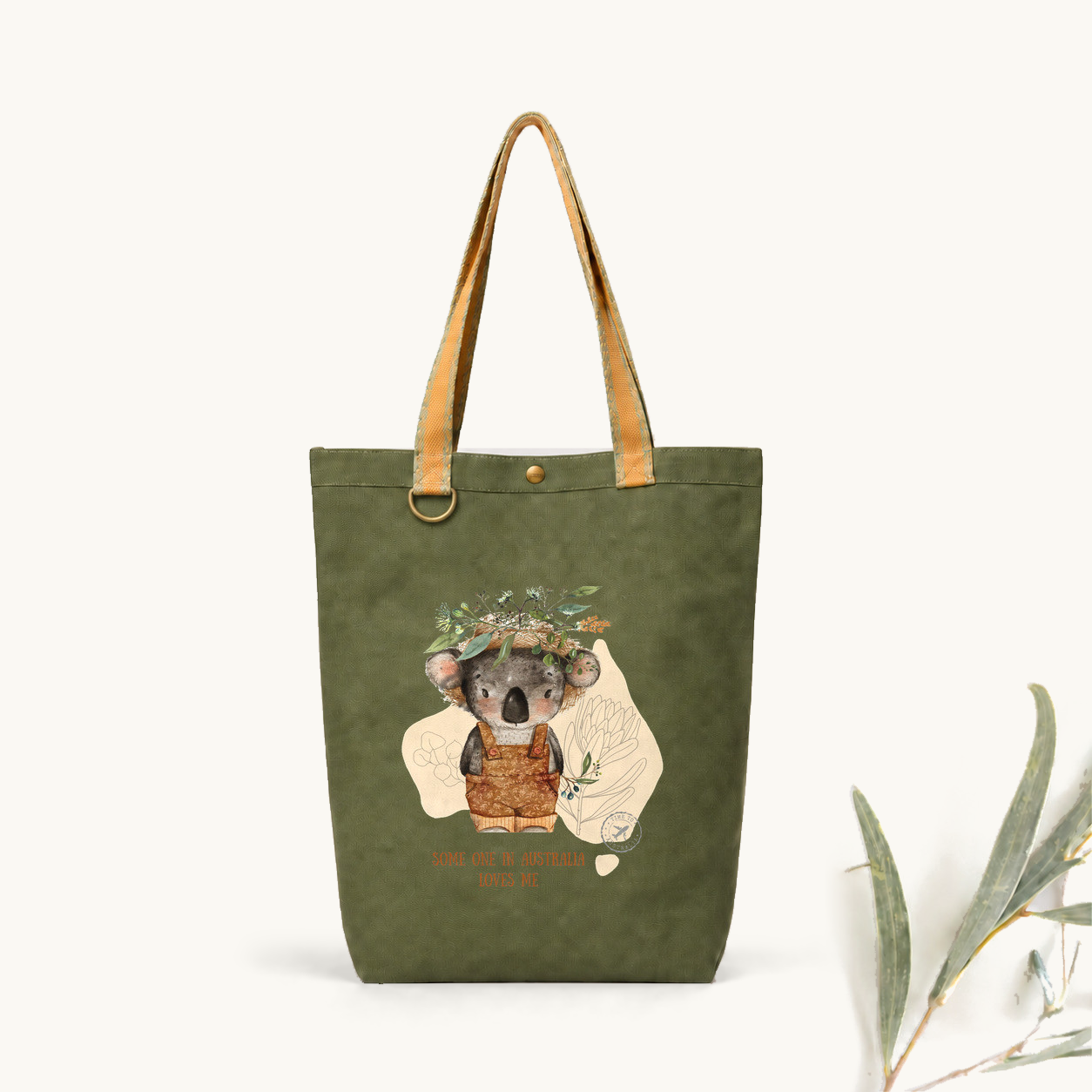 Green tote with patterned handles and a koala illustration